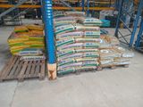 many bags of food on pallets in a warehouse