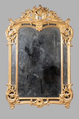 an ornate gold framed mirror with a black background