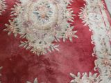 a red rug on the floor in a living room