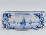 a blue and white bowl with boats in the water
