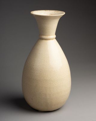 a white vase that is sitting on a table