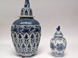 two blue and white vases sitting next to each other