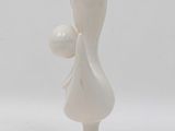 porcelain figurine of a woman holding a ball on a white base