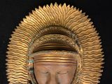 a statue of a person wearing a gold headdress