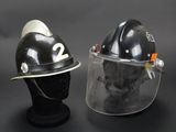 two helmets with helmets attached to them sitting on top of a table