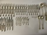 a lot of silver spoons and forks on the table