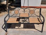 a bench that is sitting on the sidewalk in front of a building