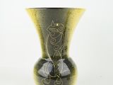 a black vase with a gold design on it