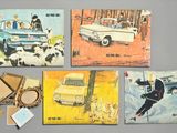 four postcards with pictures of a car, sheep, and a man in a car