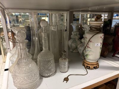 de nombreux vases en verre posés sur une étagère dans un magasin