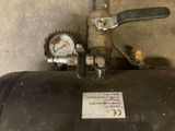 a metal tank with a pressure gauge attached to it