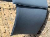 a close up of a blue seat on a bench