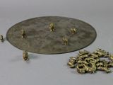 a lot of tiny gold figurines sitting on a table