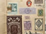 an open book with stamps on it sitting on top of a table