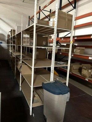 many shelves with boxes and bins in a warehouse