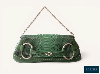 a green purse with a chain hanging from it ' s handle
