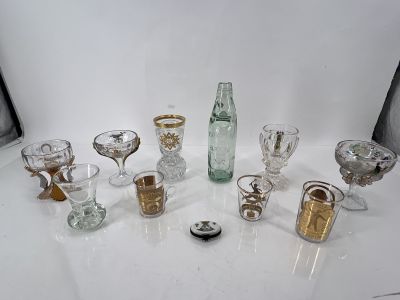 a lot of glasses and a bottle on the table