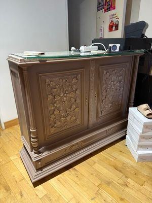 a wooden desk with a glass top in a room