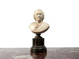a bust of a man sitting on top of a table