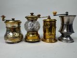 three different types of coffee grinders are lined up on a table
