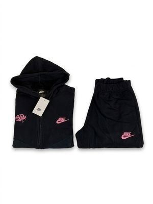 a black jacket and pants with a pink nike logo on it