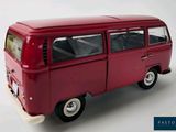 a red toy van that is sitting on a white surface