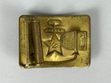 a close up of a metal belt buckle with a star on it