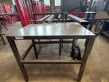 the table is made of wood and has wheels on it