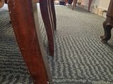 a cat that is sitting under a table in a room