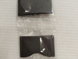 two pieces of plastic hair clips on a white surface