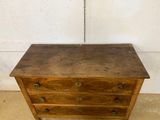 an old wooden chest of drawers with a chain hanging from it ' s side