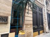 a palm tree in a planter on the side of a building