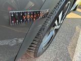a close up of a car ' s tire with a sticker on it