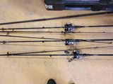 a lot of fishing rods on the floor next to a pair of shoes
