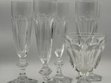 four wine glasses sitting on a table next to each other