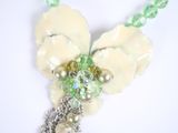 a close up of a necklace with pearls and beads on it