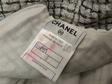 a close up of a chanel label on a white jacket