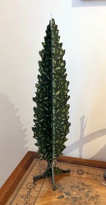 un petit sapin de Noël posé sur une table à côté d'une lampe