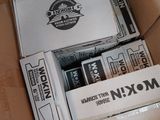 a cardboard box filled with boxes of cigarettes and a box of cigarettes