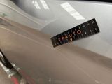 a sticker on the hood of a car with a ruler attached to it