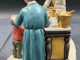 a figurine of a woman and a child in a kitchen