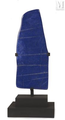 a close up of a blue stone sculpture on a black stand