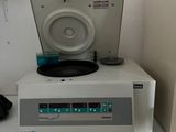 a record player sitting on top of a white shelf