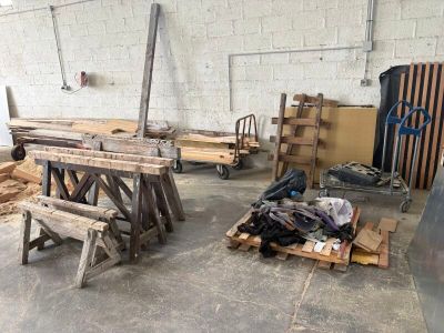 several pieces of wood are stacked on top of pallets in a warehouse