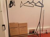 a rack with clothes hanging on it in a room