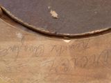 a close up of a piece of wood with writing on it