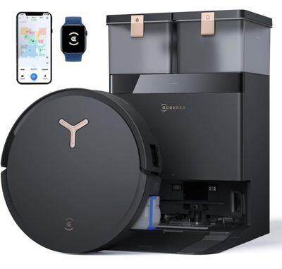 un gros plan d'une machine à café noir à côté d'un smartphone