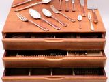 a wooden drawer with silverware and silverware in it
