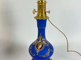 an image of a blue and gold lamp on a white background