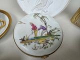 a small box with a painting on it next to a pair of scissors